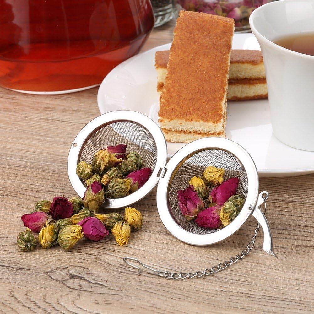 Picture of mesh infuser ball open with chamomile tea falling out